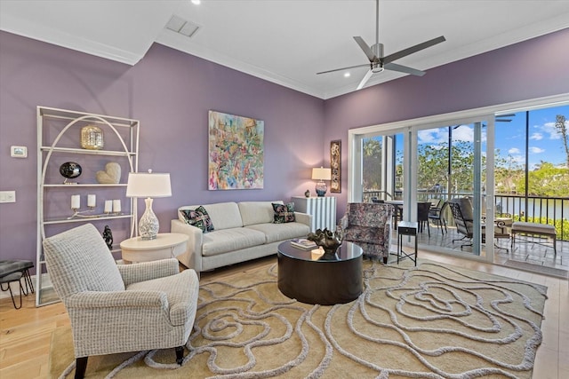 living room featuring ceiling fan, light hardwood / wood-style flooring, and ornamental molding