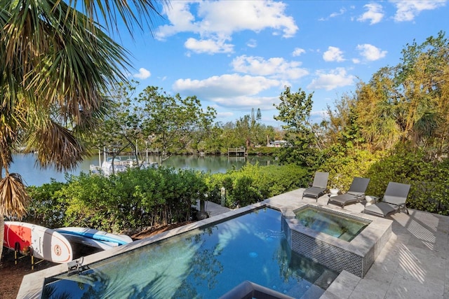 view of pool featuring an in ground hot tub and a water view