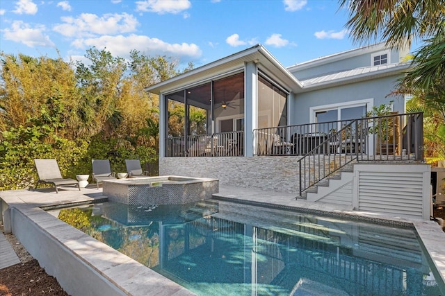 view of pool with a sunroom, an in ground hot tub, ceiling fan, and a patio