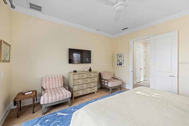 bedroom with hardwood / wood-style floors, ceiling fan, and ornamental molding