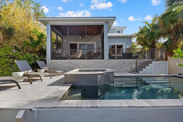 view of swimming pool with ceiling fan, an in ground hot tub, and a patio