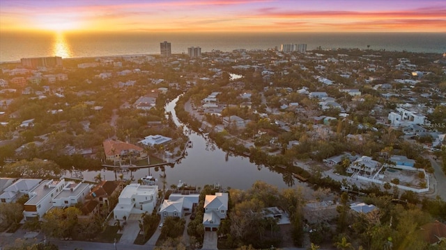 aerial view at dusk with a water view