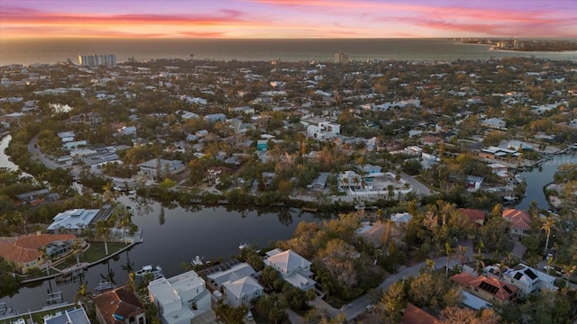 aerial view at dusk with a water view