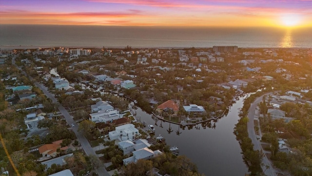 aerial view at dusk with a water view