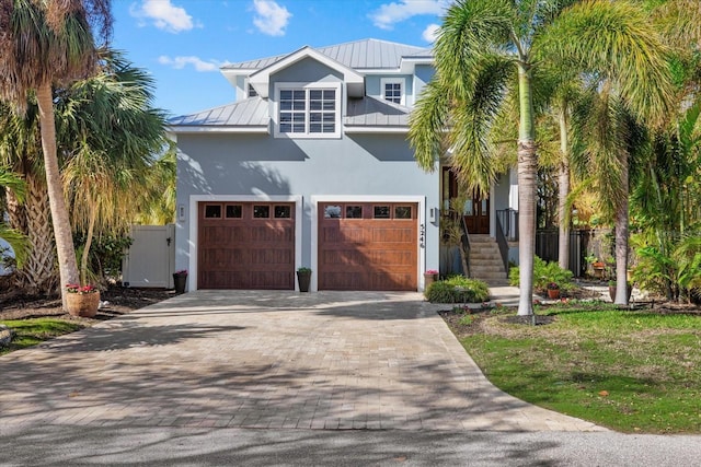 raised beach house featuring a garage