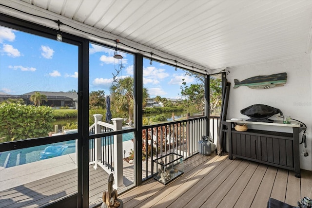 deck with a water view and a pool