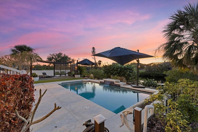 pool at dusk with a patio