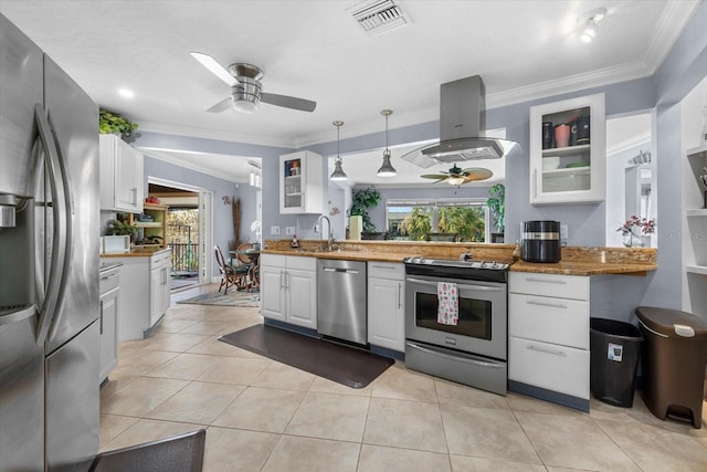 kitchen featuring white cabinets, hanging light fixtures, light stone countertops, island range hood, and stainless steel appliances