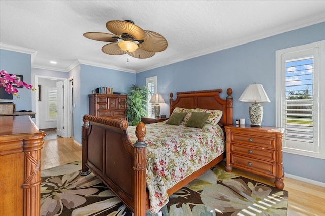 bedroom with ceiling fan, light hardwood / wood-style flooring, and crown molding