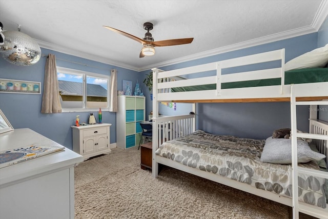 carpeted bedroom with a textured ceiling, ceiling fan, and ornamental molding