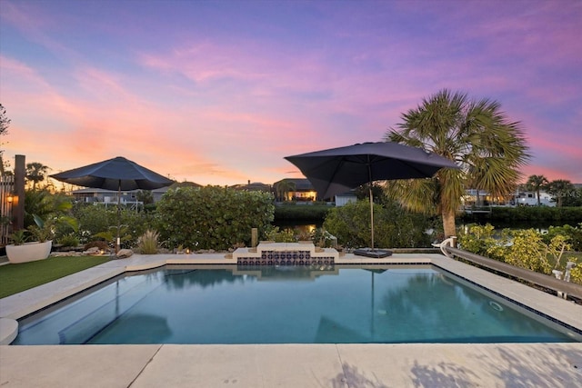 view of pool at dusk