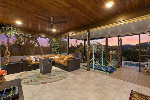 patio terrace at dusk with an outdoor living space and ceiling fan