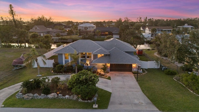 view of front of home with a yard and a garage