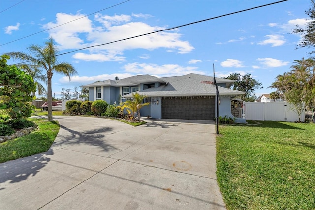 view of front of home with a garage and a front lawn