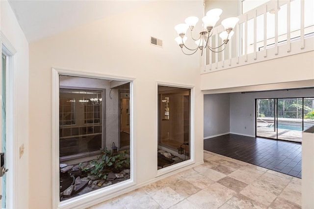 interior space with high vaulted ceiling and a notable chandelier