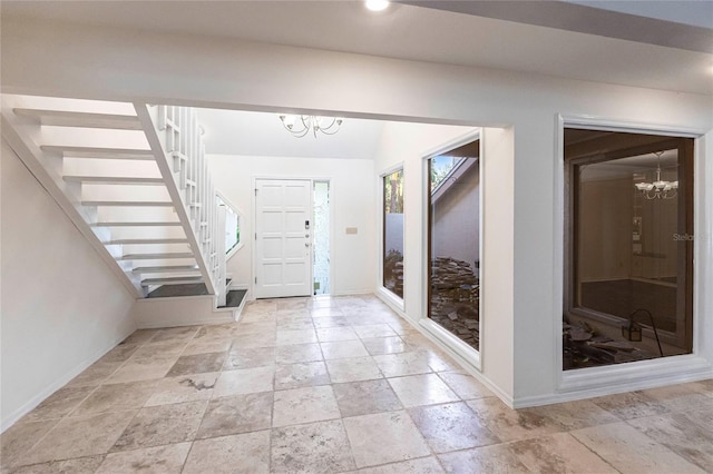 foyer featuring a chandelier