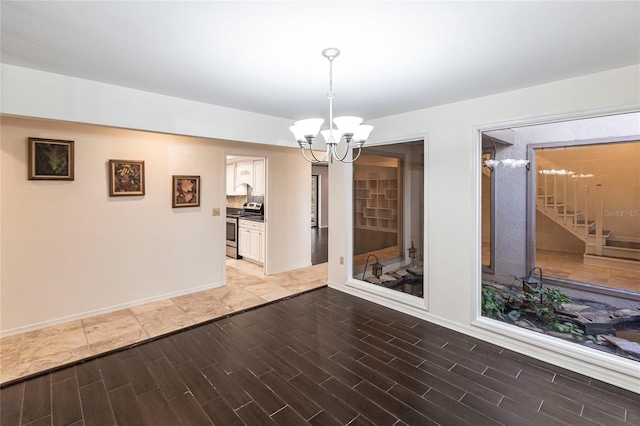 unfurnished dining area with an inviting chandelier and wood-type flooring