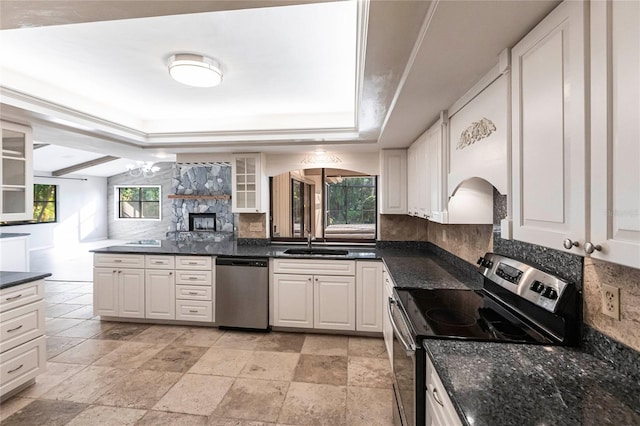 kitchen with white cabinets, appliances with stainless steel finishes, sink, and tasteful backsplash