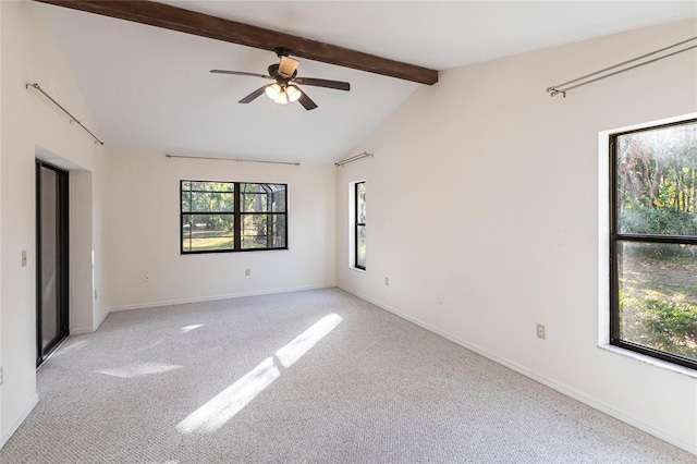 carpeted empty room with ceiling fan and lofted ceiling with beams