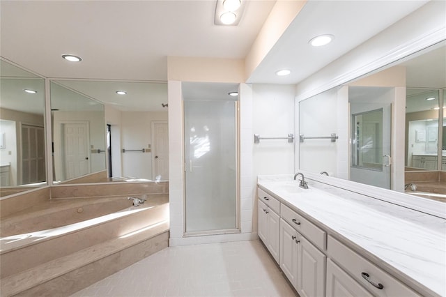 bathroom featuring tile patterned flooring, vanity, and plus walk in shower