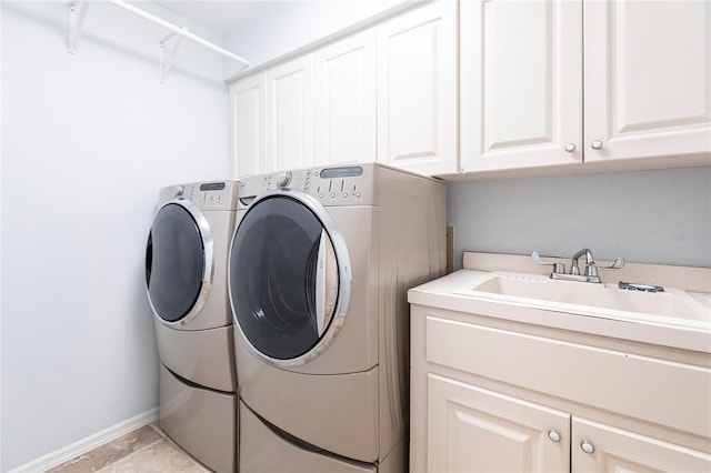 washroom with cabinets, sink, and separate washer and dryer