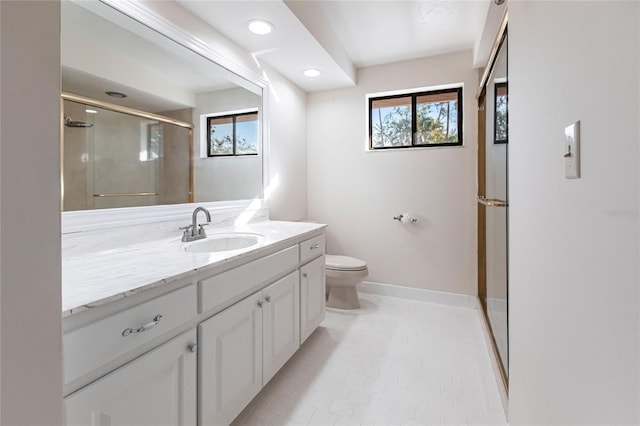 bathroom featuring a shower with shower door, tile patterned flooring, toilet, and vanity