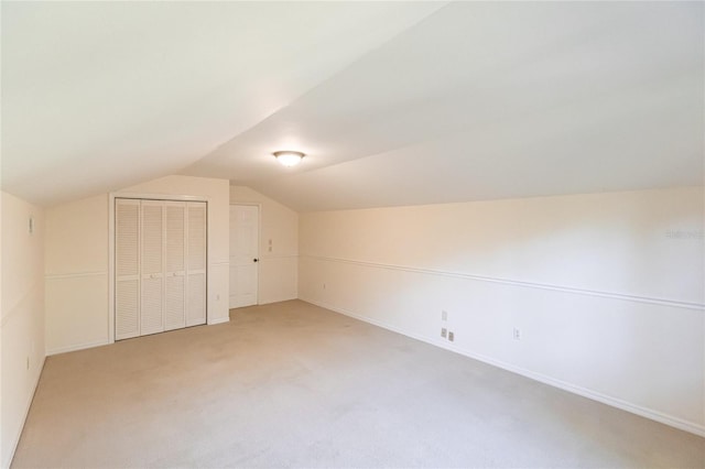 bonus room with carpet floors and lofted ceiling