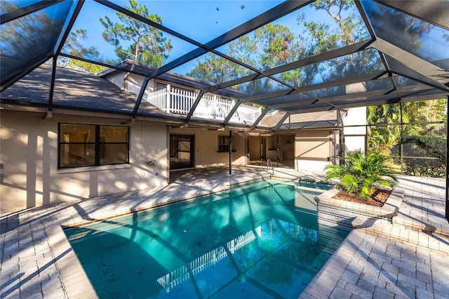 view of swimming pool with a patio and glass enclosure