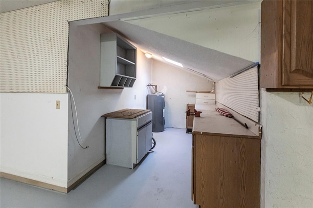 kitchen featuring lofted ceiling and electric water heater