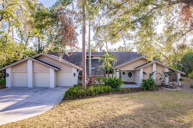 ranch-style house featuring a garage and a front yard