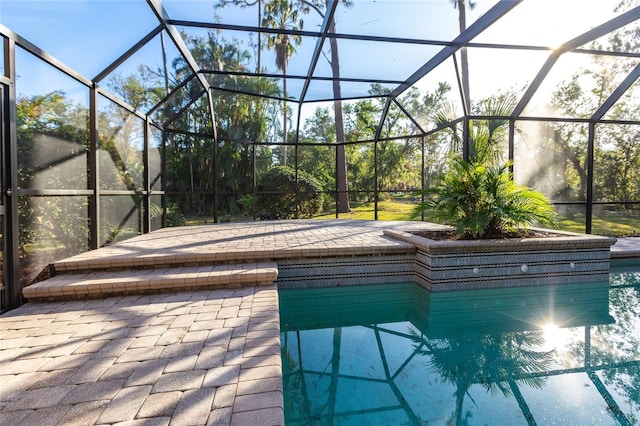 view of pool with a patio and a lanai