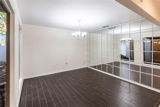 spare room featuring a notable chandelier