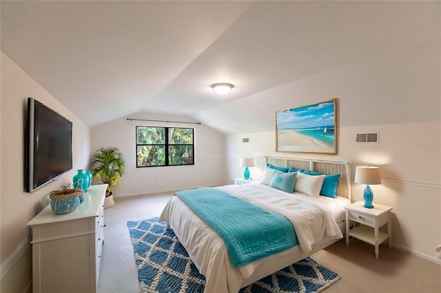 bedroom with light wood-type flooring and lofted ceiling