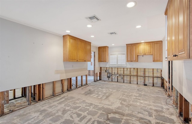 kitchen with crown molding, light brown cabinetry, and light colored carpet