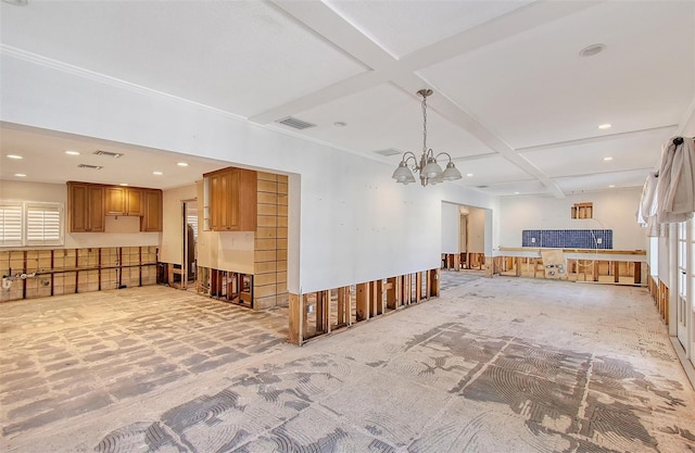 living room with a chandelier and coffered ceiling