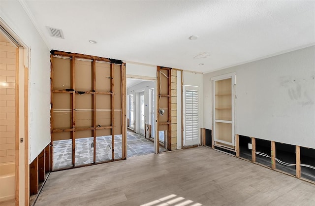 unfurnished bedroom featuring hardwood / wood-style flooring and crown molding