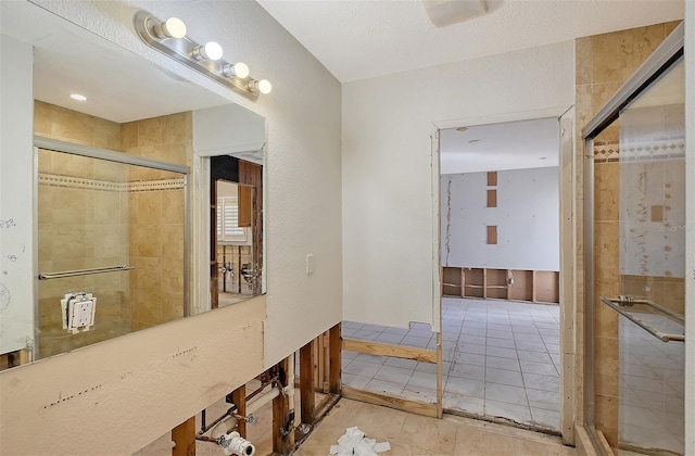 bathroom with tile patterned flooring and a shower with door