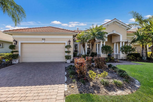 mediterranean / spanish-style house with a garage