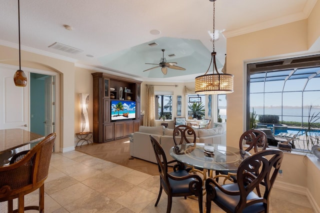 tiled dining room featuring ceiling fan and ornamental molding