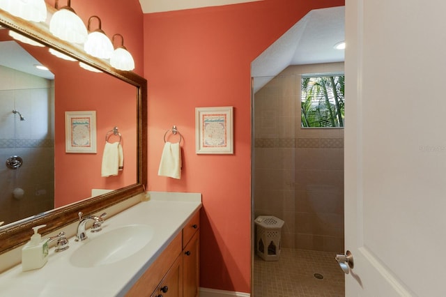 bathroom featuring vanity and tiled shower