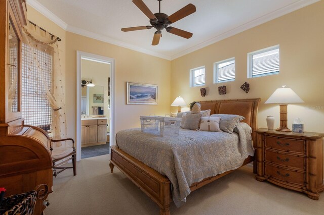 bedroom with ceiling fan, ornamental molding, light carpet, and ensuite bath