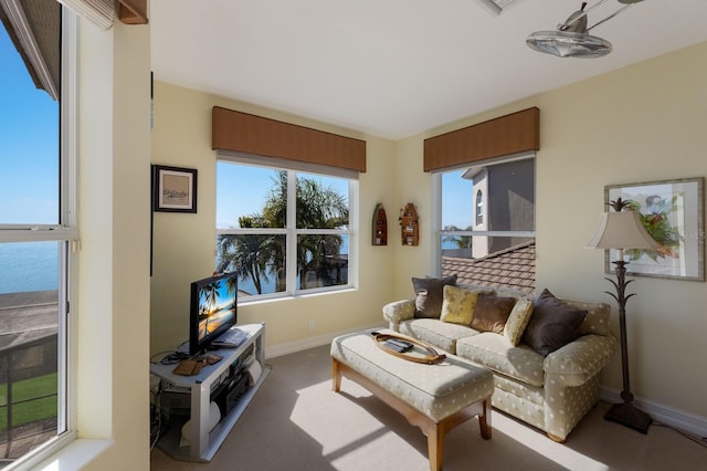 living room with carpet and a water view