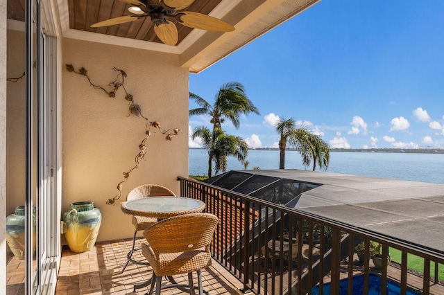 balcony featuring ceiling fan and a water view