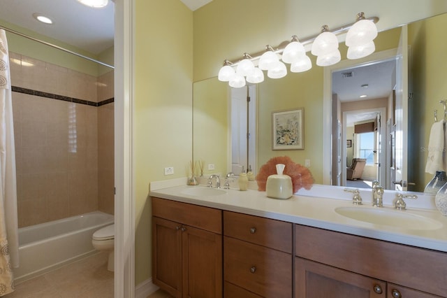 full bathroom featuring tile patterned flooring, vanity, toilet, and shower / tub combo