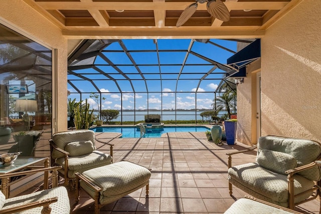 view of swimming pool with a patio area, a lanai, an in ground hot tub, and a water view