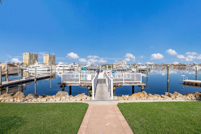 view of dock featuring a water view and a yard