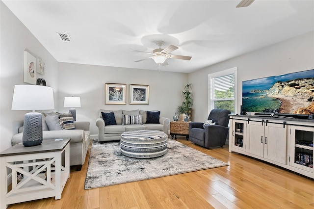 living room featuring ceiling fan and light wood-type flooring