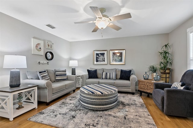 living room with ceiling fan and light hardwood / wood-style floors