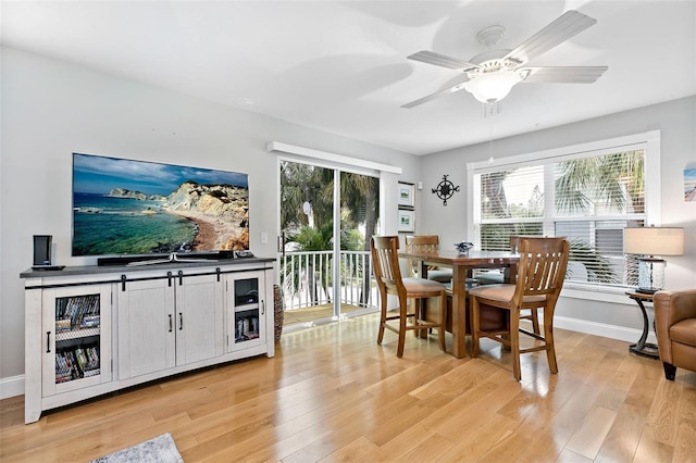 dining space with light wood-type flooring and ceiling fan