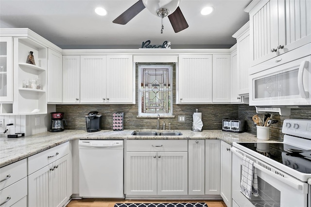 kitchen featuring decorative backsplash, white cabinetry, white appliances, and sink